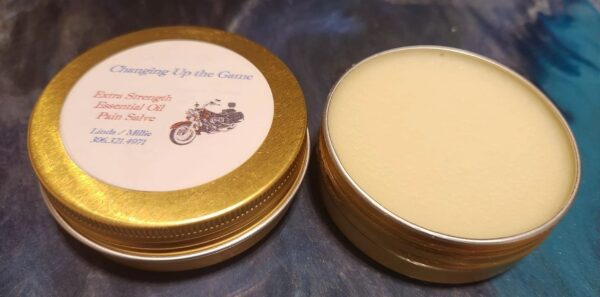 A gold tin of cream sitting on top of a table.