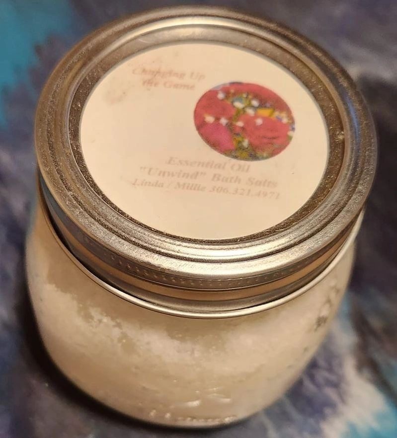 A jar of body butter sitting on top of a table.